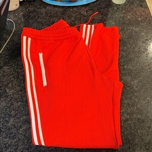 adidas Men's bright orange track pants with White Stripes